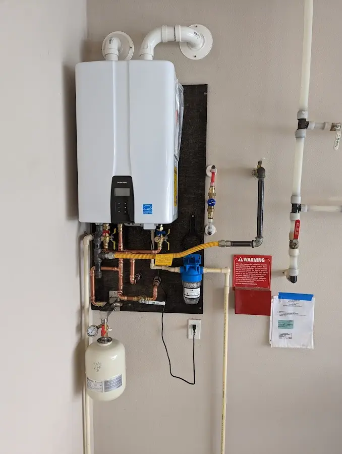 Professional plumber installing copper piping in a Connell home